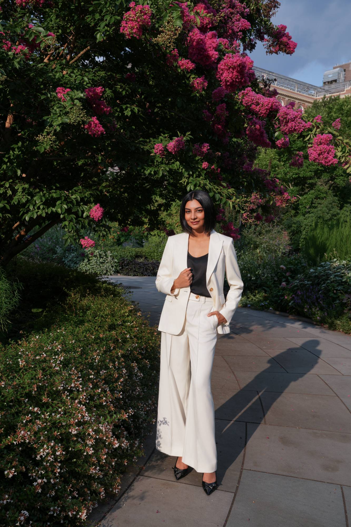 Dr. Zunaira Khan, DMD, dentist at Chelsea Gardens Dental, standing in a Chelsea garden